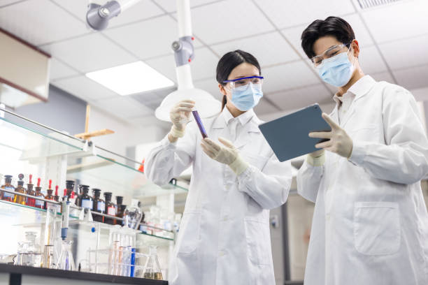 Scientists are working at chemical lab. stock photo
