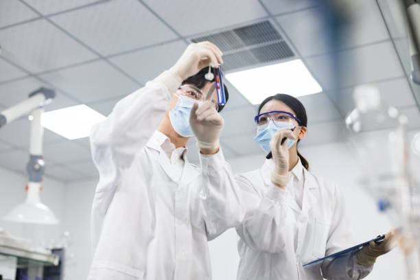 Scientists are working at chemical lab. stock photo