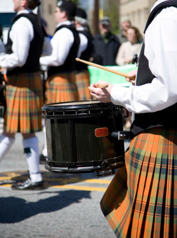 Detail on a  drum player part of a traditionnal scottish pipe marshing band. Shot on Saint Patrick's day parade in Atlanta Georgia..