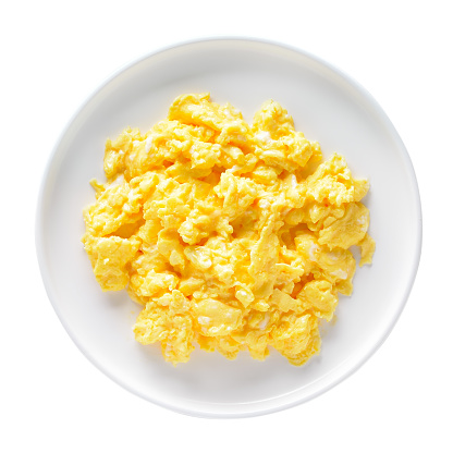Scrambled eggs on plate isolated on white background. Top view, flat lay
