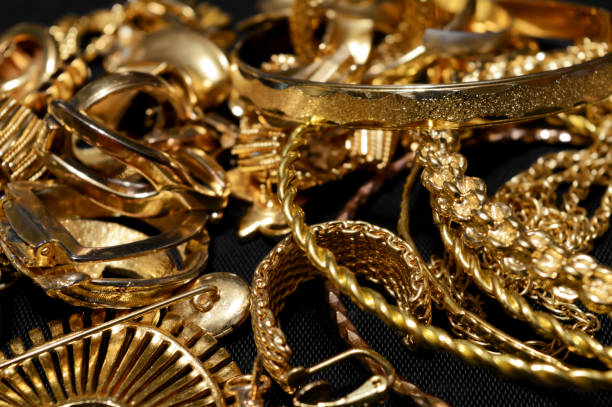 Scrap Gold Refining Closeup view of some scrap gold ready for refining. gold jewelry stock pictures, royalty-free photos & images