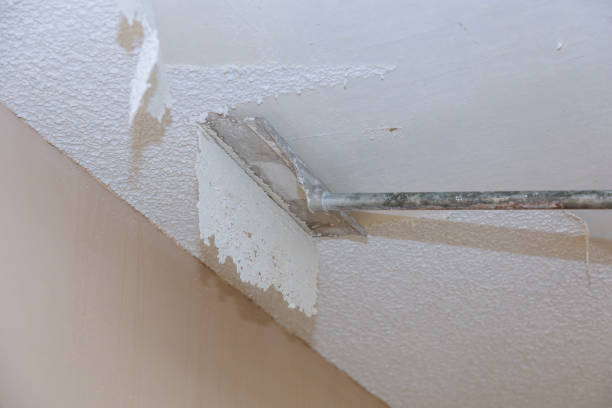 Scrapping a popcorn ceiling house renovation stock photo