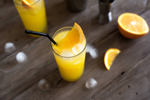 Screwdriver Cocktail, vodka and orange juice Screwdriver Cocktail with vodka, ice and orange juice. Homemade screwdriver cocktail drink on wooden table, copy space. screwdriver drink stock pictures, royalty-free photos & images
