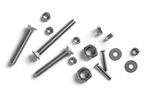 Set of chrome screws and bolts on white background