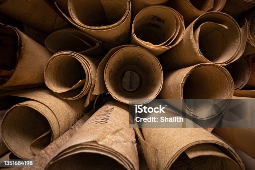istock Scrolls with futhpak symbols stacked on pile. Ancient scribe library. 1351684198