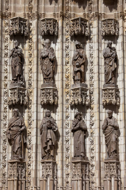 Stone sculptures of saints on the Seville Cathedral Gothic facade in...