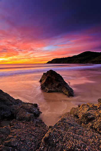 Scenic seascape of Burgess beach in Forster town on Australian pacific coast at colourful sunrise.