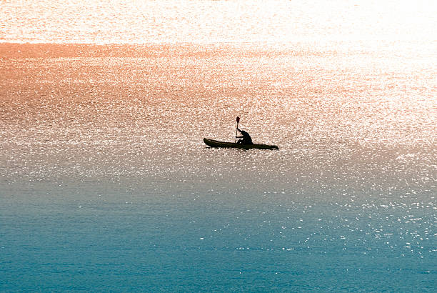 Sea canoeist (water sports) at dawn stock photo