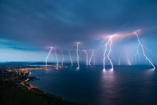 Sea City Lightning Storm Storm approaching sea city Trieste (Friuli Venezia Giulia region of Italy) from Gulf of Trieste. risk photos stock pictures, royalty-free photos & images
