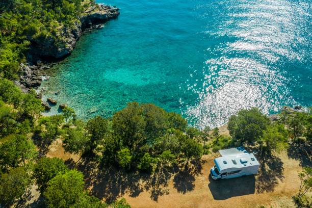 Sea Front RV Campsite Aerial Photo of Scenic Sea Front RV Campsite. Modern Motorhome Camper Van on the Mediterranean Sea Croatian Coast. Vacation on the Road. Turquoise Bay. croatia stock pictures, royalty-free photos & images