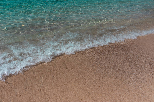 Sea wave on the sandy beach stock photo