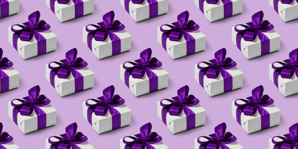 Seamless pattern with cute gifts on purple background. Boxing day. stock photo