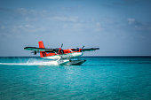 istock Seaplane landing in the ocean lagoon. 673536918