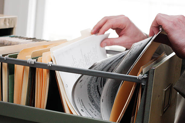 Searching through files Paperwork in a filing cabinet top secret stock pictures, royalty-free photos & images