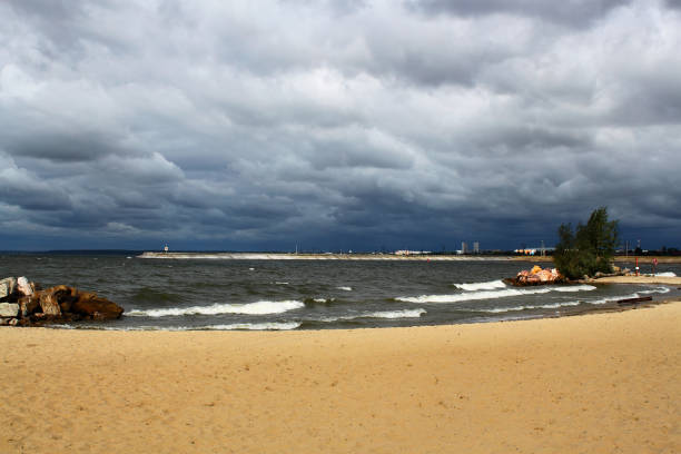 Seascape. Sandy beach. Gloomy cloudy sky. stock photo