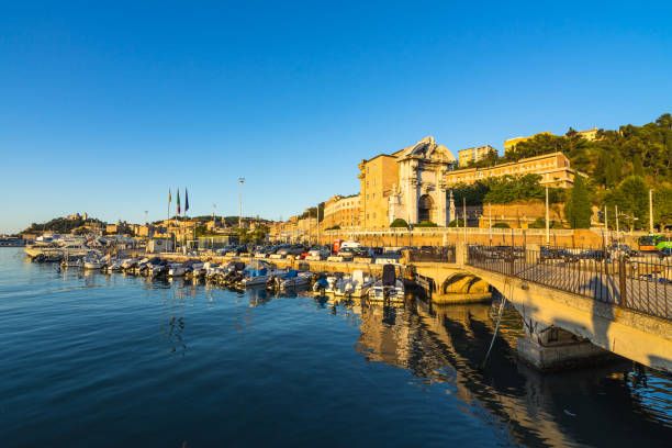 Seascape with Ancona harbor and boat docked at sunset, Marche, Italy stock photo