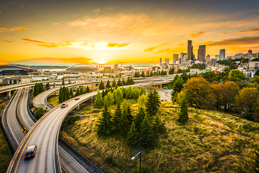 Seattle skylines and Interstate freeways converge at sunset, Seattle, Washington, USA.