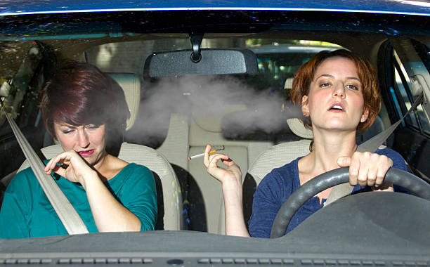 Second Hand Smoke From a Driver Smoking in a Car stock photo