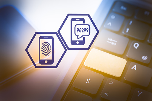 Two Hexagon Icons symbolising Secure Athetication in Front of a Smartphone and a Laptop Computer