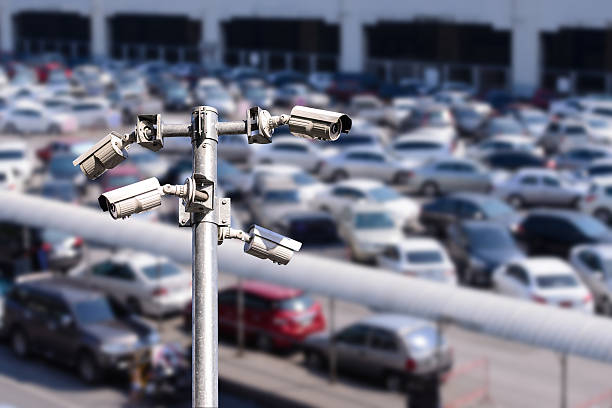 Security camera monitoring outdoor car park. stock photo