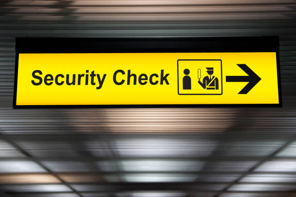 security check sign hanging from airport terminal ceiling stock photo