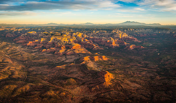 Sedona sunrise aerial view over Red Rock Country Arizona USA First light of daybreak illuminating the dramatic red rock landscape, mountains, buttes and mesas of Sedona, an aerial panorama from high above this popular recreation and vacation area in Arizona, Southwest USA. ProPhoto RGB profile for maximum color fidelity and gamut. flagstaff arizona stock pictures, royalty-free photos & images