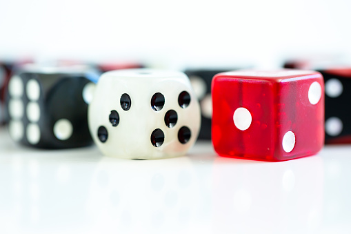 Selection of dice of different colours. White background with copy space