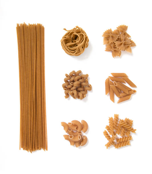 selection of whole grain pasta, isolated on white background: spaghetti, tagliatelle, farfalle, cellentani, penne, fussili selection of whole grain pasta, isolated on white background: spaghetti, tagliatelle, farfalle, cellentani, penne, fussili wholegrain stock pictures, royalty-free photos & images