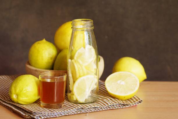 Selective focus lemon and lemon slice with glass of honey on wooden  table  prepare  for made a healthy drink    , food and drink image for background or wallpaper stock photo