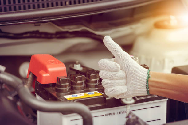 Selective focus, Man hand checking car battery on car engine system stock photo