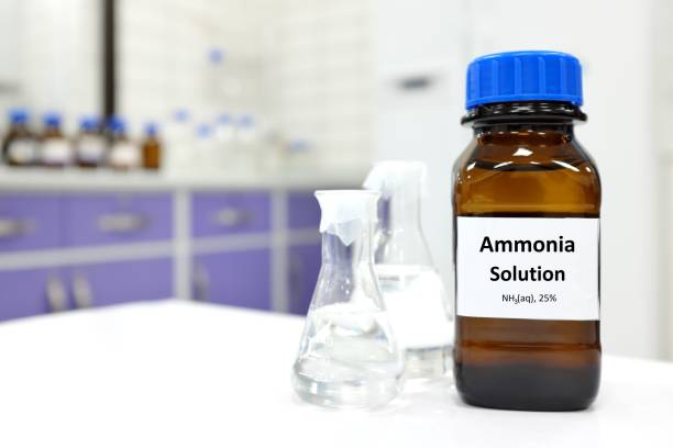 Selective focus of ammonia solution or ammonium hydroxide in glass amber bottle inside a chemistry laboratory with copy space. Selective focus of ammonia solution or ammonium hydroxide in glass amber bottle inside a chemistry laboratory with copy space. ammonia stock pictures, royalty-free photos & images
