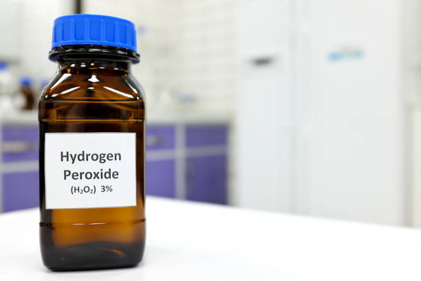 Selective focus of hydrogen peroxide solution in brown amber bottle. Blur laboratory background with copy space. Selective focus of hydrogen peroxide solution in brown amber bottle. Blur laboratory background with copy space. hydrogen peroxide stock pictures, royalty-free photos & images
