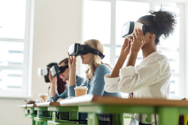 selective focus of multiethnic students using vr headsets in university - vr glasses imagens e fotografias de stock