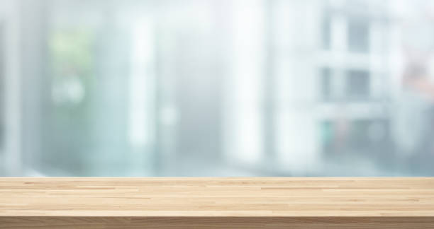 Selective focus of wood table top on white wall glass (big window) background Selective focus of wood table top on white wall glass (big window) background.For montage product display or design key visual layout focus on foreground stock pictures, royalty-free photos & images