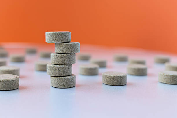 selective focus photo of DGL (licorice root extract) chewable tablets. dietary concept: tower of DGL tablets. dietary supplement topview stock photo