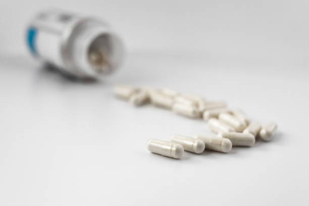 selective focus photo of lithium orotate capsules, poured out of the jar. dietary concept. dietary supplement limited depth of field photo stock photo