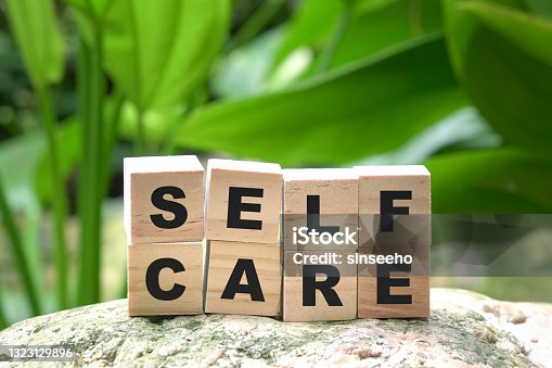 istock Self care word on wood cubes on green nature background. 1323129896
