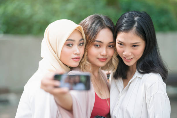 Self Portrait Of The Beauties Three girls taking selfie outdoors. ::::: asian beauties : stock pictures, royalty-free photos & images