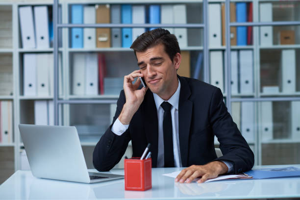 Self-confident manager on phone Arrogant funny businessman grimacing while talking to business partner on the phone in office arrogance stock pictures, royalty-free photos & images