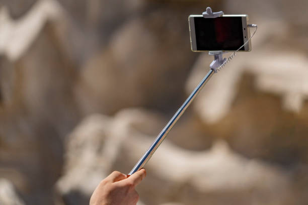 selfie remote control on cellular smartphone stock photo