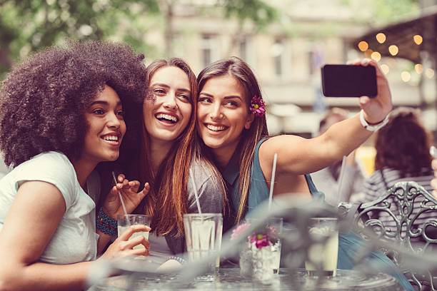 Selfie time Friends taking selfie at sidewalk cafe drinking photos stock pictures, royalty-free photos & images