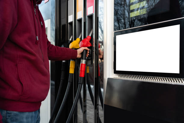 Self-service filling station Self-service filling station. A man using a touchscreen fuel pump stock pictures, royalty-free photos & images