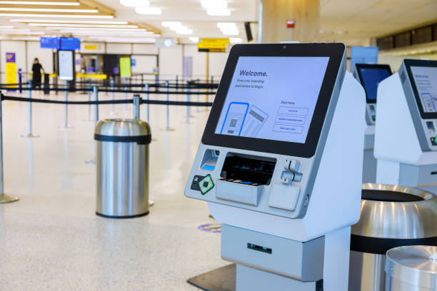 Self-service technology in transportation of self check-in kiosk in airport terminal passport scanning and ticket printing machine stock photo