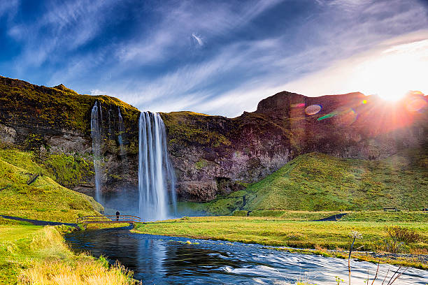 Seljalandsfoss Waterfall Against the Sun, South Iceland Seljalandsfoss Waterfall against the sunlight,  South Iceland cataract stock pictures, royalty-free photos & images