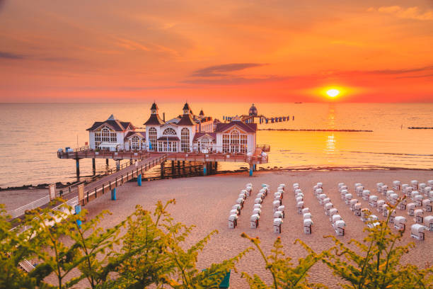 Sellin Pier at sunrise, Baltic Sea, Germany Famous Sellin Seebruecke (Sellin Pier) in beautiful golden morning light at sunrise in summer, Ostseebad Sellin tourist resort, Baltic Sea region, Germany rügen stock pictures, royalty-free photos & images