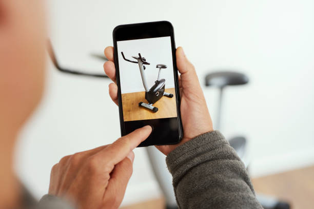 selling an exercycle on an online marketplace app stock photo