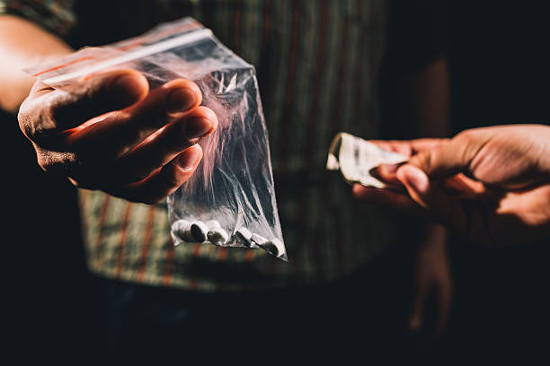Selling illegal pills Dealer selling cocaine,ecstasy or other illegal drugs cannabis narcotic photos stock pictures, royalty-free photos & images