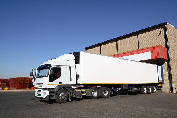 Semi truck at storage warehouse . stock photo