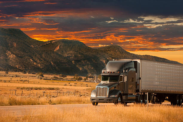 semi truck sunset stock photo