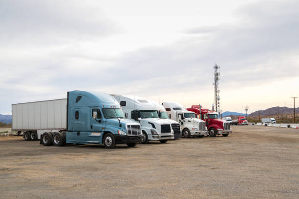 Semi Trucks parked at a  road side truck stop along a highway stock photo